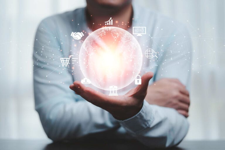 An open hand holding a glowing globe surrounded by business icons